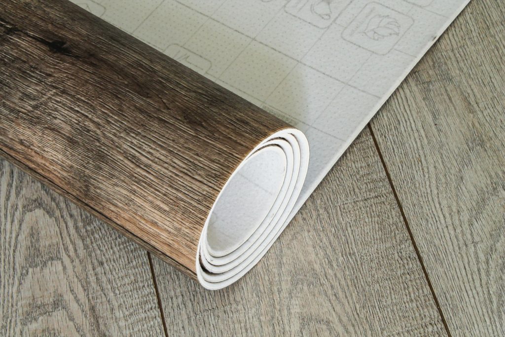 Roll of linoleum with a wood texture. Types of floor coverings.